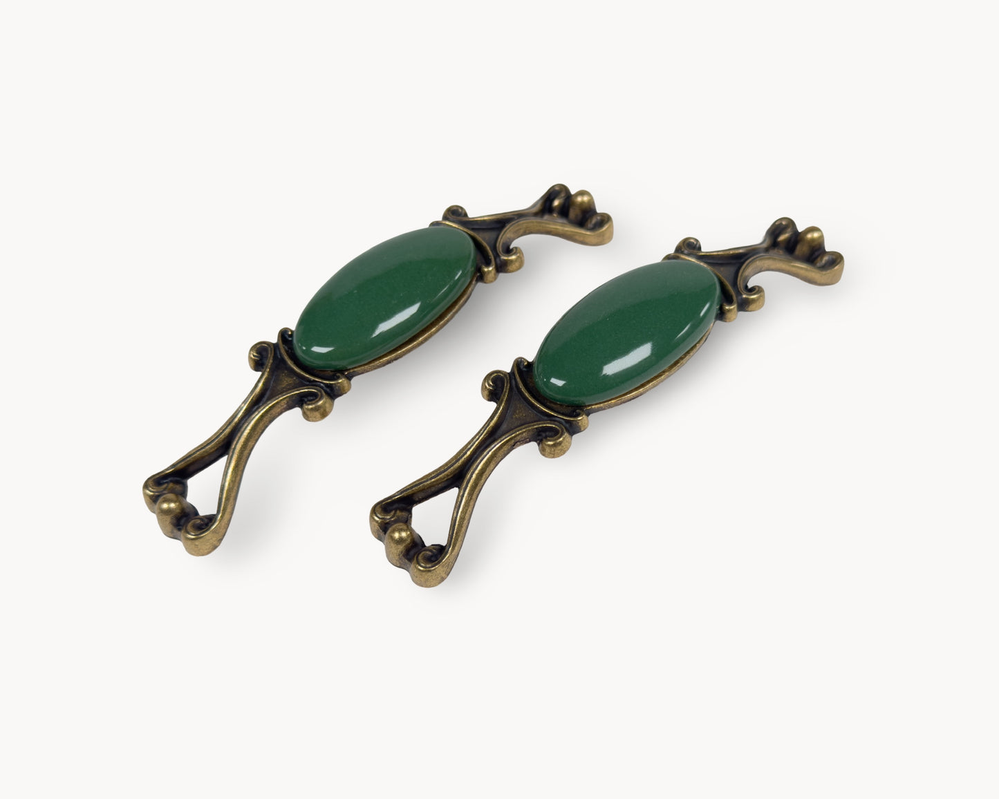 Belnua - Pair of decorative handles with dark green porcelain and brass accents from Nureya collection on a white background