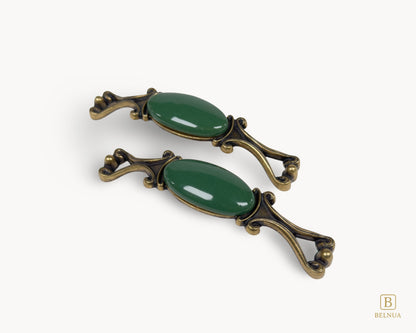 Belnua - Front and top view of Nureya decorative cabinet handle pair with dark green porcelain and brass base  on a white surface
