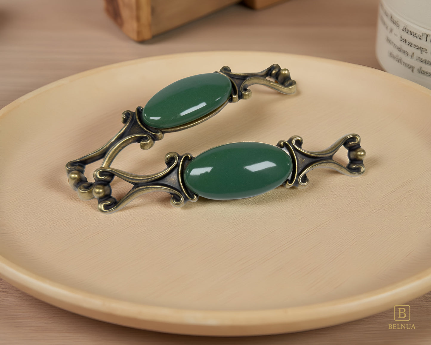 Belnua - Pair of Nureya decorative cabinet handles with dark green porcelain and brass base  on a wood plate