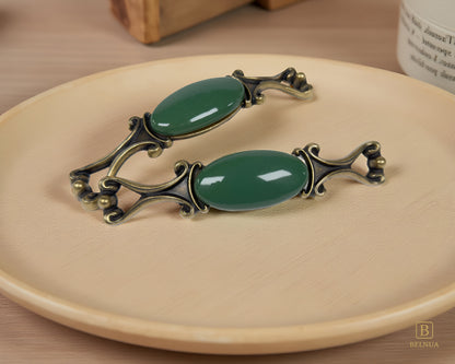 Belnua - Pair of Nureya decorative cabinet handles with dark green porcelain and brass base  on a wood plate