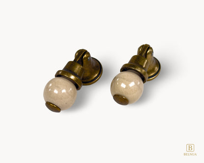 Belnua - Left angled view of Virella orange porcelain insert and sculptural antique brass base