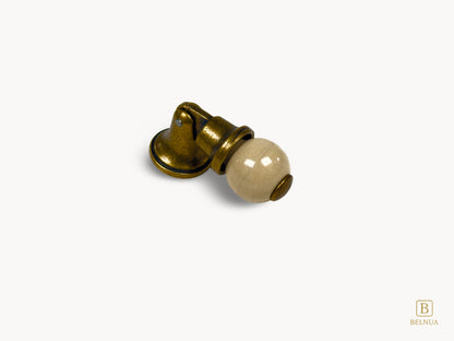 Belnua - Right angled view of orange porcelain insert and sculptural antique brass base