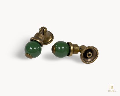 Belnua - Flat lay front and back view of VIRELLA porcelain cabinet knob pairs showing in antique brass and green pairing