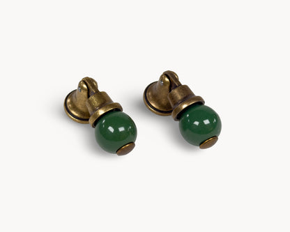 Belnua - Right angled view of VIRELLA porcelain cabinet knob pairs showing in antique brass and green pairing