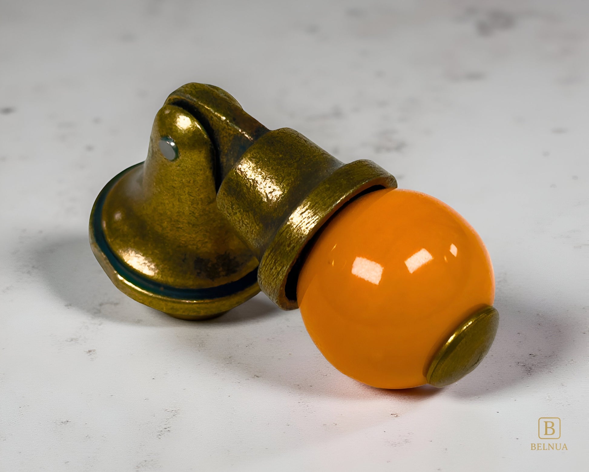 Belnua - VIRELLA knob in antique brass finish with smooth orange porcelain with marble surface