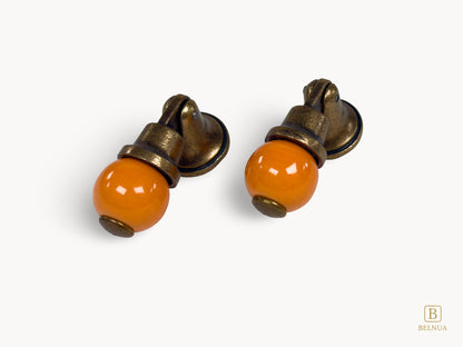 Belnua - Pair of left angled photo of orange and antique brass combination on VIRELLA knob