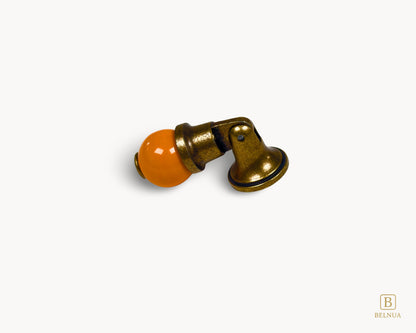 Belnua - Flat lay and back of Belnua’s antique brass knob with orange porcelain