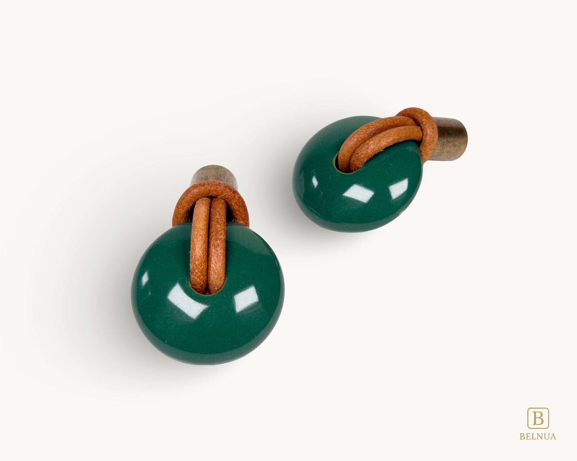 High-resolution shot of two green porcelain furniture knobs with vintage brass accents, ideal for upcycling projects.