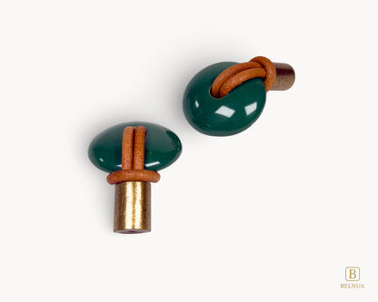 Side profile of a Belnua Revina green knob showing the elegant contrast between the brass metal and polished porcelain.