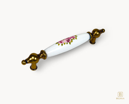 Angled view of Lumora 128mm antique brass floral porcelain handle