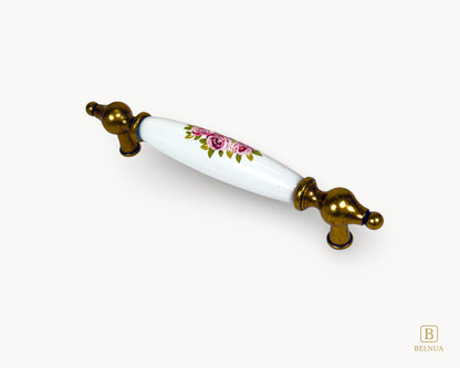 Perspective view of 128mm Lumora antique brass porcelain cabinet handle