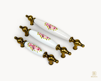 Lumora antique brass porcelain cabinet handles with floral design shown in all sizes