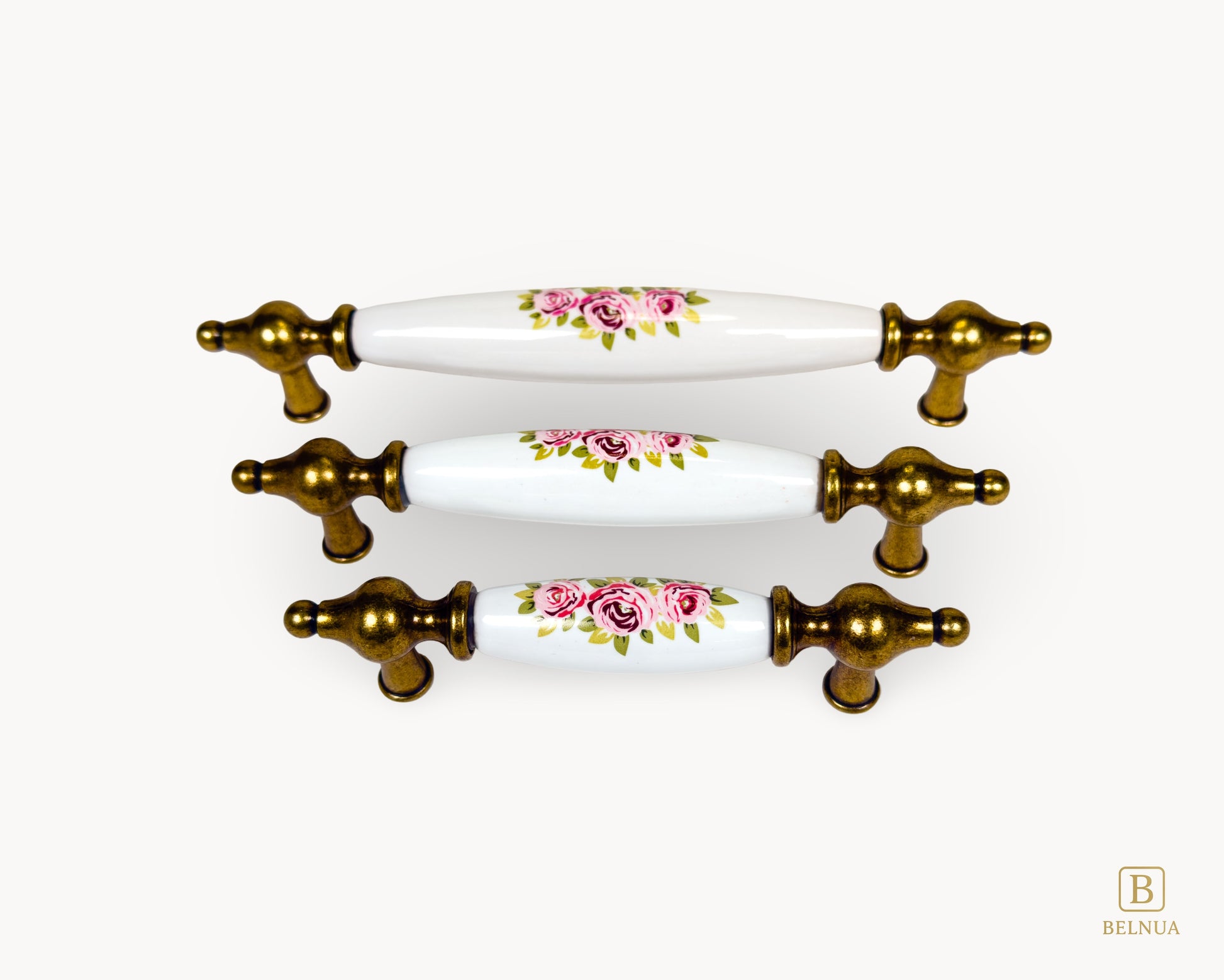 Perspective view of Lumora antique brass porcelain handles with floral pattern