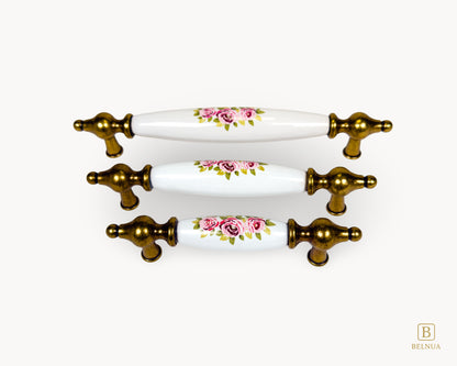 Perspective view of Lumora antique brass porcelain handles with floral pattern