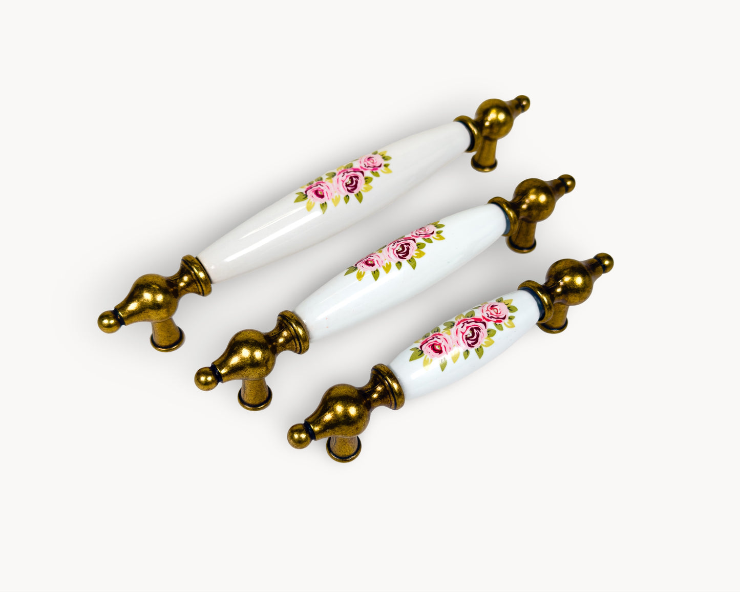 Belnua - Angled view of Lumora antique brass floral porcelain cabinet handle collection