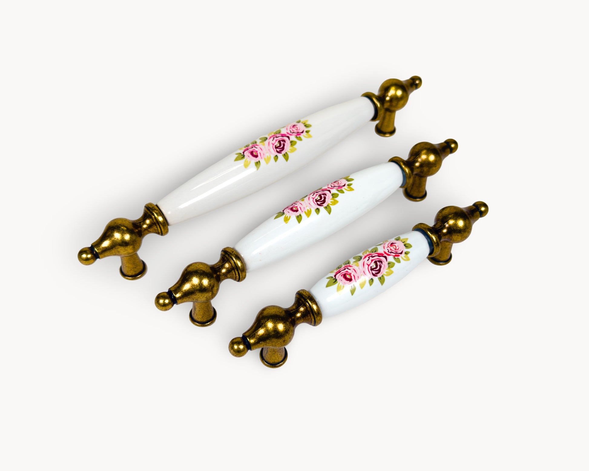 Belnua - Angled view of Lumora antique brass floral porcelain cabinet handle collection