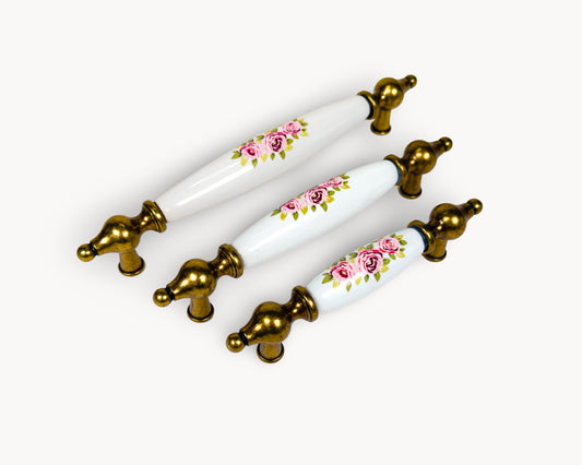 Belnua - Angled view of Lumora antique brass floral porcelain cabinet handle collection