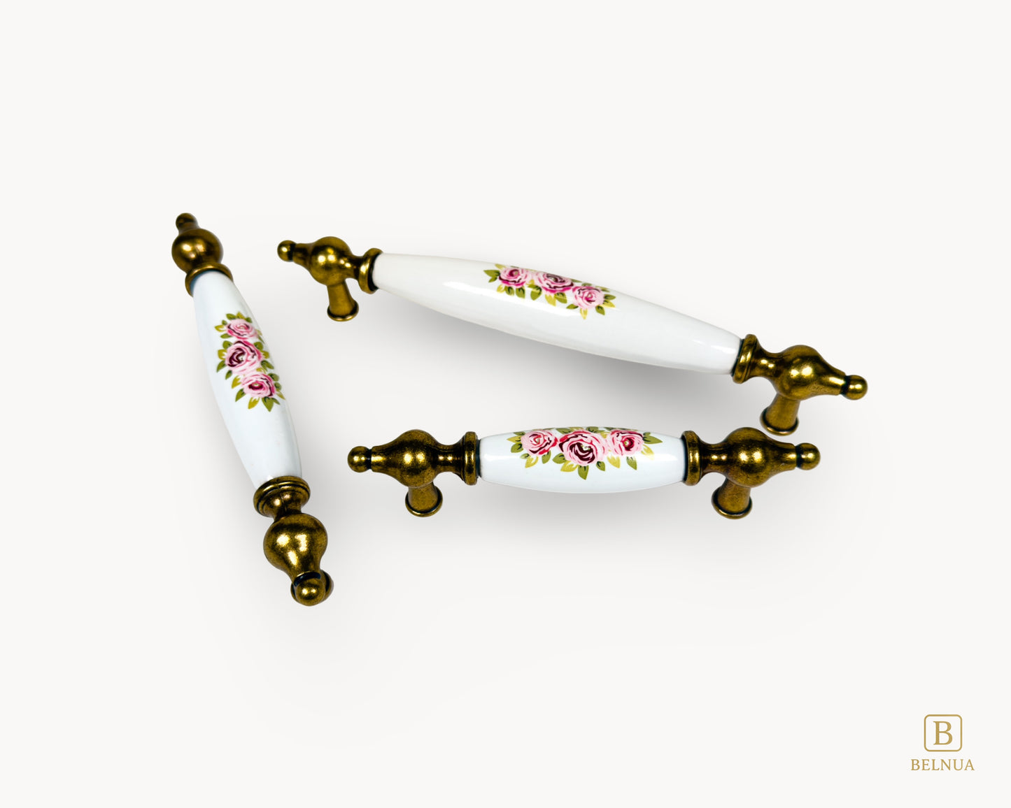 Multiple size layout of Lumora antique brass floral porcelain cabinet handles