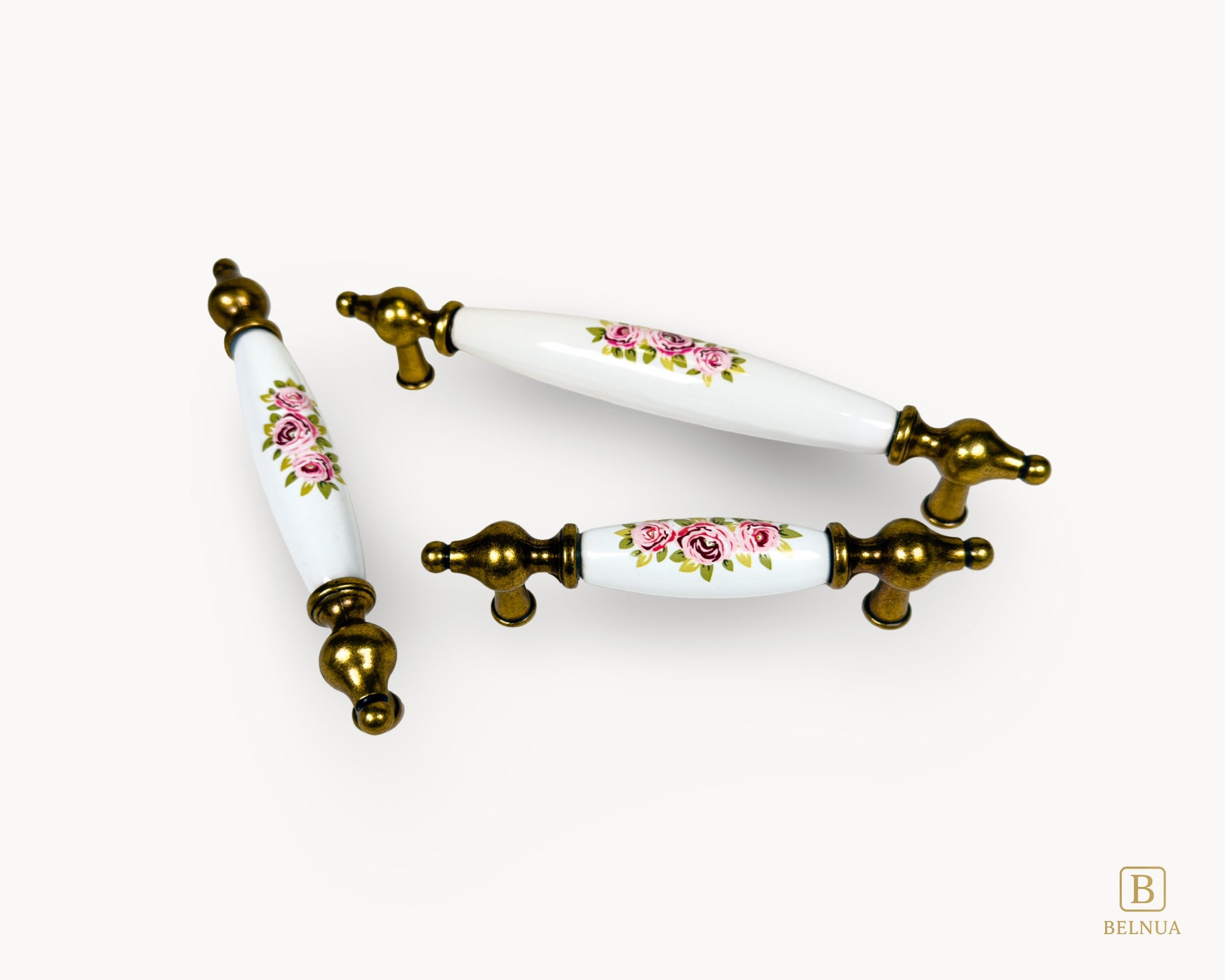 Multiple size layout of Lumora antique brass floral porcelain cabinet handles
