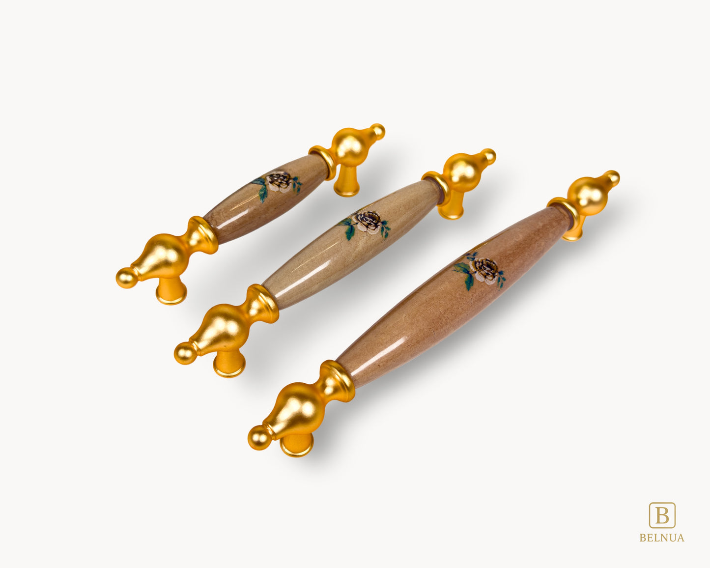 Gold cabinet handle from Lumora collection featuring decorative porcelain insert